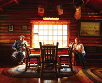 a simply furnished living room in  a log cabin