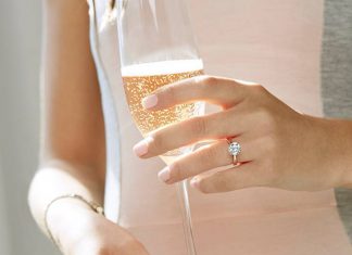 5 Small Changes That Will Help You Save Big on Your Wedding Woman with diamond engagment ring holding champagne
