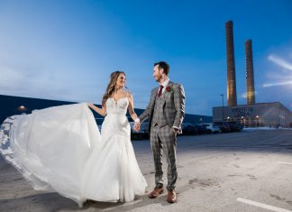 A couple standing in front of Northern Stacks Events in Fridley