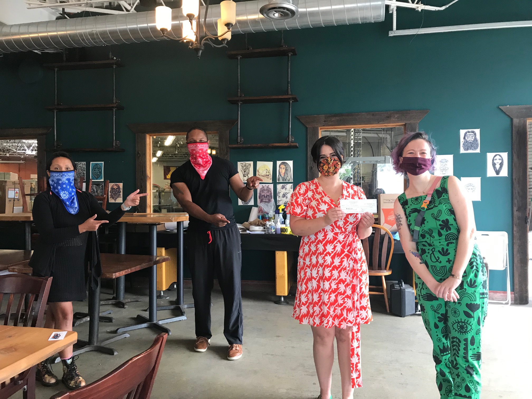 Chris Montana (second from left) and Tina Rexing, of the Du Nord Foundation, with Good Luck High Five, a Minneapolis-based media company