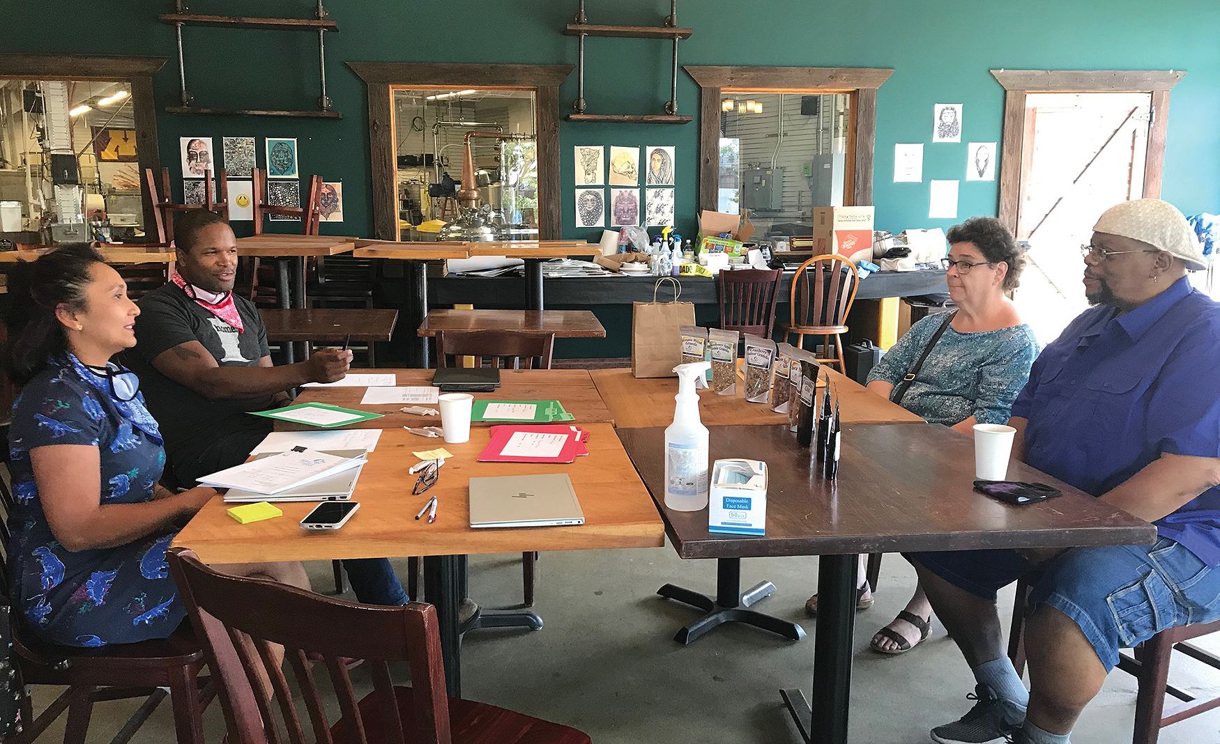 Chris Montana and Tina Rexing (left) meet with applicants of the Du Nord Riot Recovery Fund inside Du Nord Craft Spirits’ cocktail room