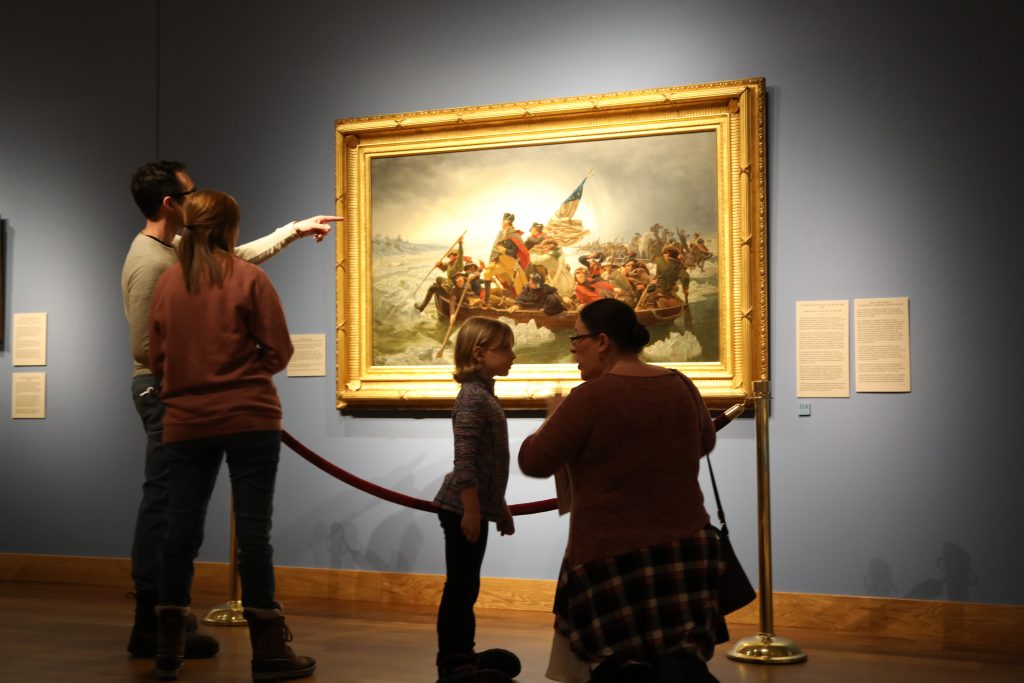 Guests at Minnesota Marine Art Museum look at Washington Crossing the Delaware painting