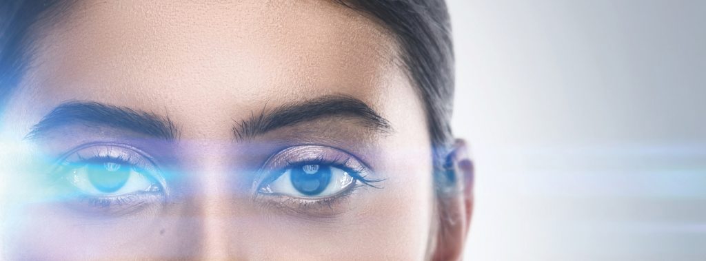 Indian woman in light of optical flares. Concepts of laser eye surgery or visual acuity check-up