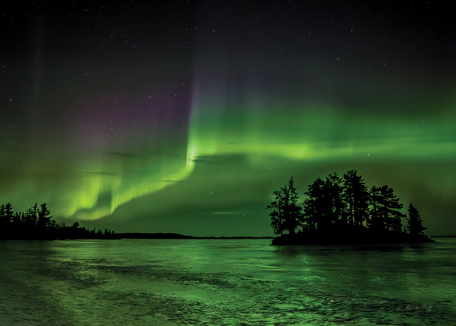 The northern lights dance above Cranberry Bay in the upper reaches of Voyageurs National Park