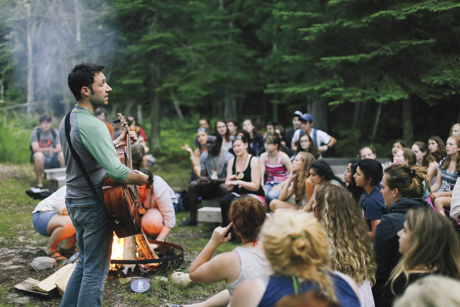 Attendees of the Lac du Bois French immersion camp sing songs around the fire