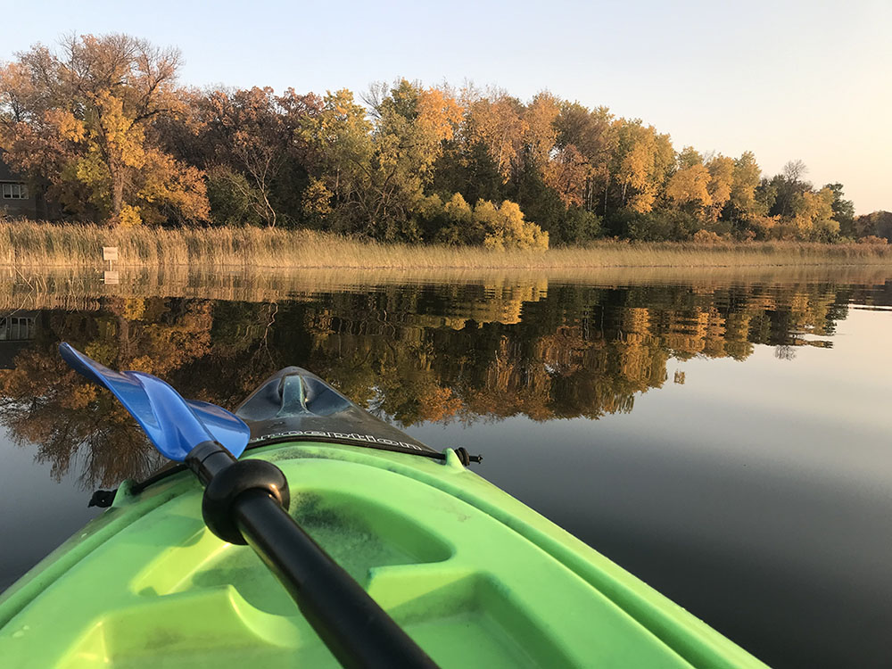 Front of a green kayak on the water