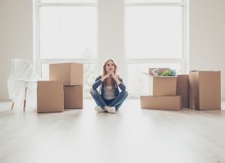 Helping Your Young Adult Thrive: Ways to Offer Financial Support With Purpose Portrait of young pretty woman sitting on the floor and thinking how to unpack all the stuff